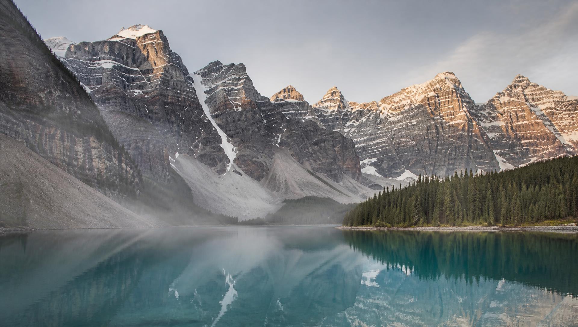 Placeholder: a glacial lake beneath mountain peaks in the Canadian Rockies